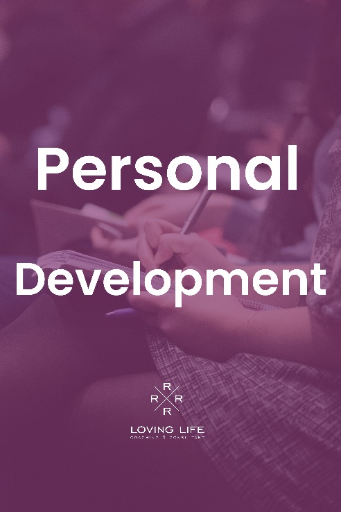 A person writing on paper with the words personal development in front of them.